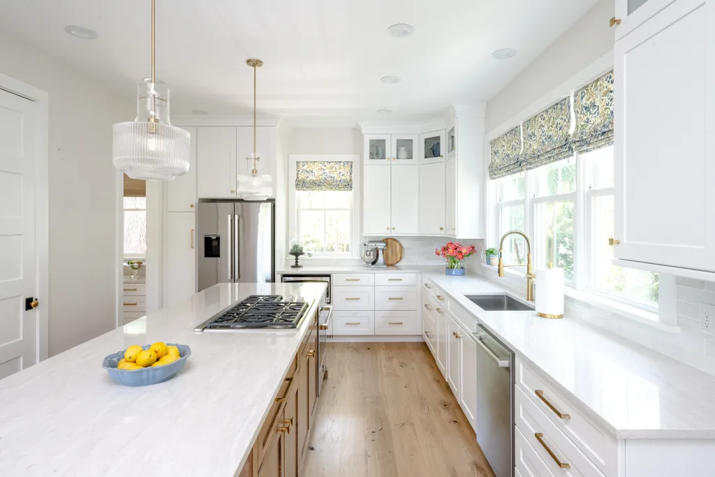 Charleston kitchen with island, brass faucet, and pendant lighting by Ryan-Marie Preuss