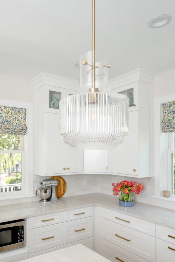 Fluted glass pendant light over kitchen counter, brass detailing by Charleston designer Ryan-Marie