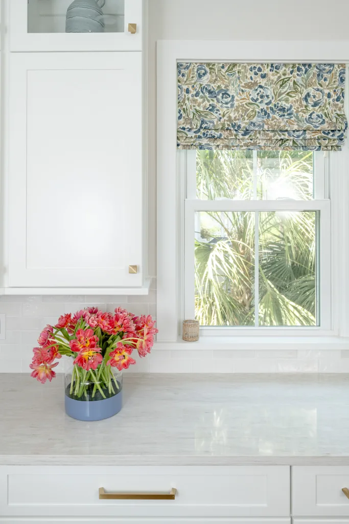 Pink tulips in blue vase on kitchen counter with botanical Roman shade, Charleston, SC